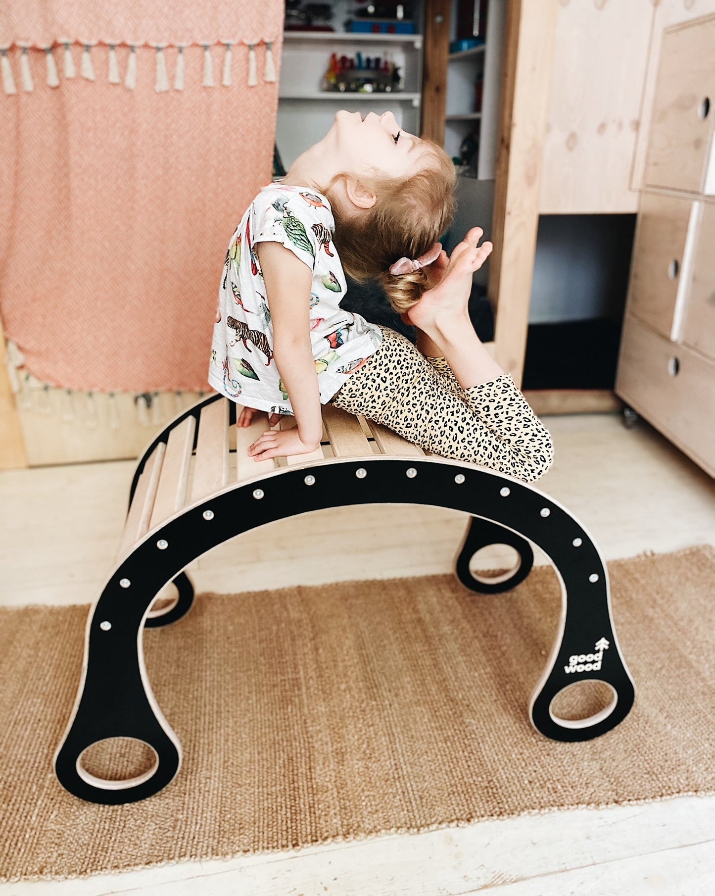 girl performing exercises on good wood rocker in black colour