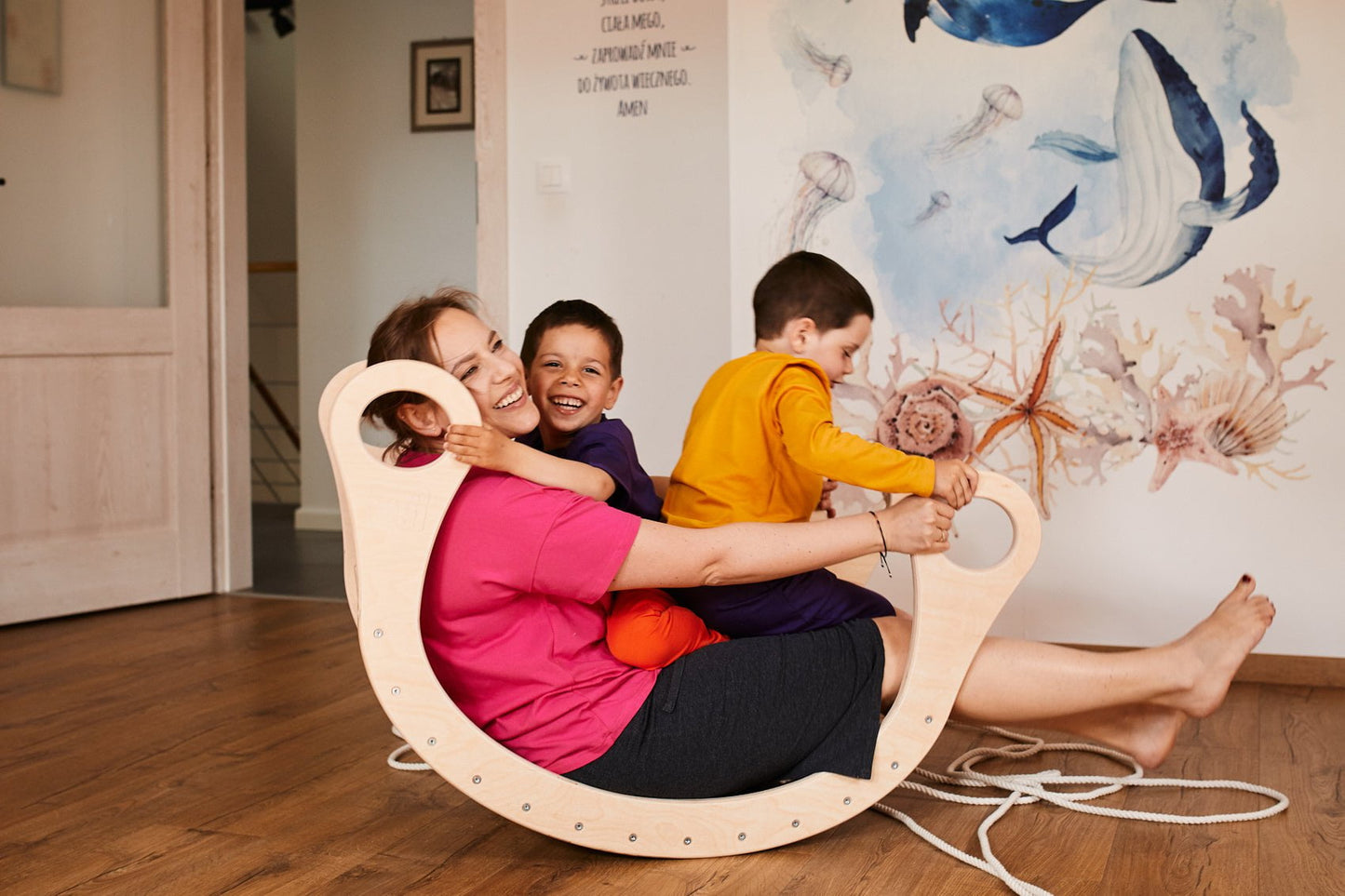 Mother with children playing in Good Wood Rocker