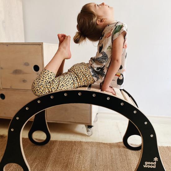 girl making a pose on the good wood rocker good wood collection sensory owl shop