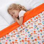 a girl sleeping under the weighted blanket with the forest party cotton print