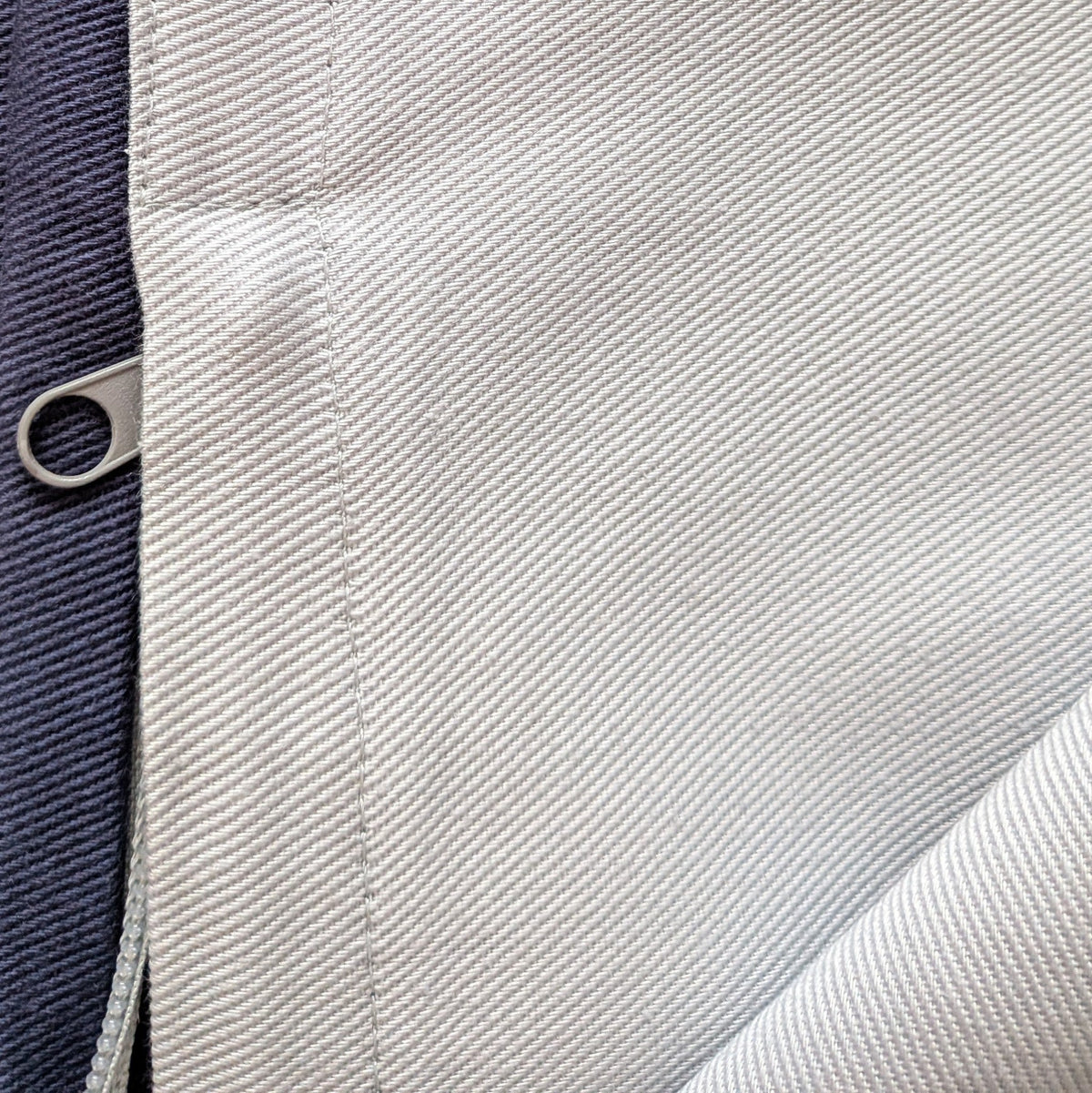Close-up of fabric texture with a zipper pull