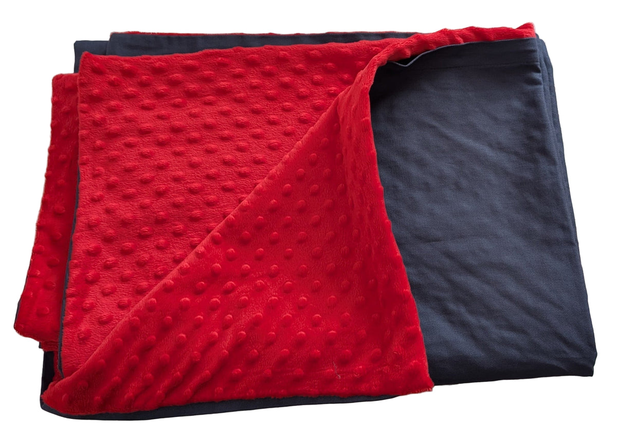 Red and grey textured blankets cover stacked on a light-colored surface