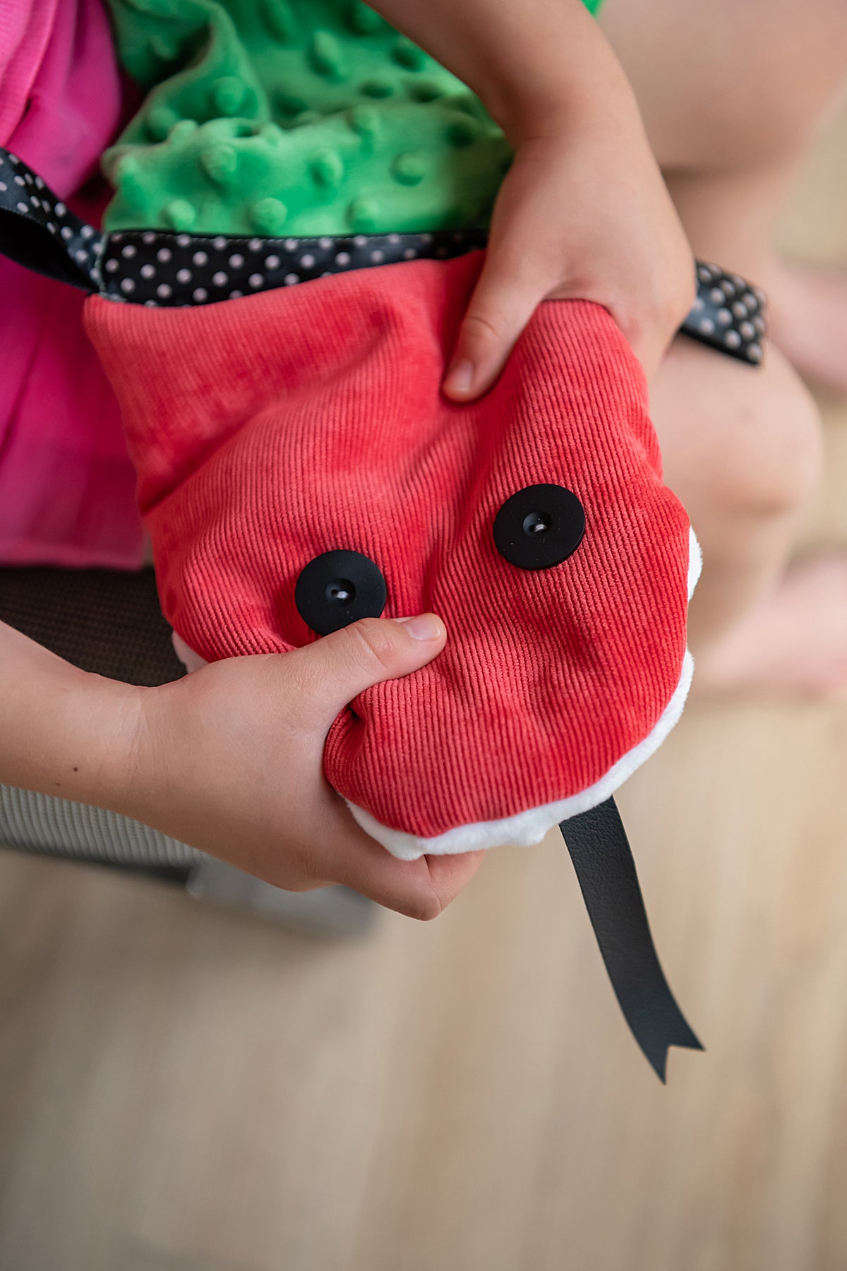 a girl squeezing a head of tactile sensory snake