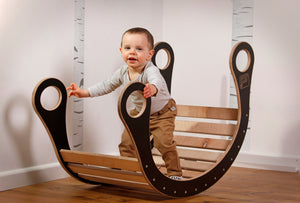 A child playing in good wood rocker colour black