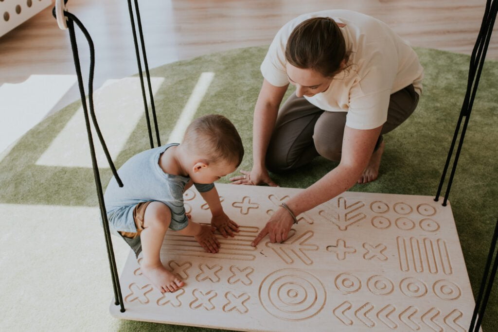 toddler and a parent exploring SENSORY PLATFORM- GOOD WOOD Media 1 of 7