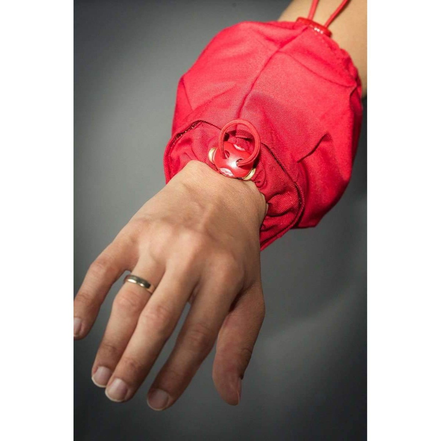 Human hand dressed in red Cotton Wrist Weights - Sensory Owl